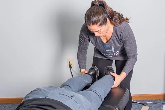 Dr. Nora Zoma adjusting a patient's legs