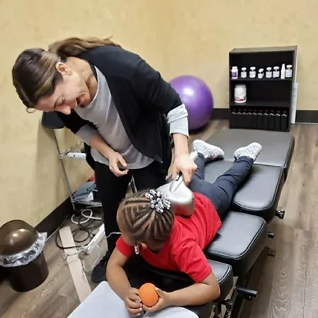 Dr. Nora Zoma with a pediatric chiropractic patient